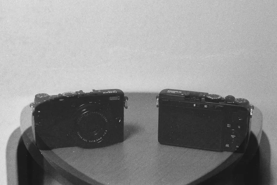 Two black digital cameras on a wooden table — So Sánh 5 Gói Internet Viettel - Chọn Gói Nào?